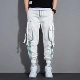 Pantalon cargo blanc de style japonais Urban Street Tactical, coupe jogger avec poches multiples, bandes contrastées et sangles décoratives.