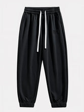 Pantalon Japonais Homme Akira noir vu de face, taille élastique et cordons blancs