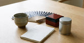 Souvenirs japonais artisanaux disposés ensemble sur une table en bois clair