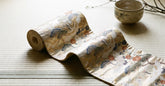 Ceinture obi en soie brochée déroulée sur un tatami dans une lumière douce
