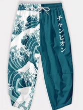 Pantalon japonais Élite Vagues en packshot, motif vague Hokusai et coupe ample bicolore.